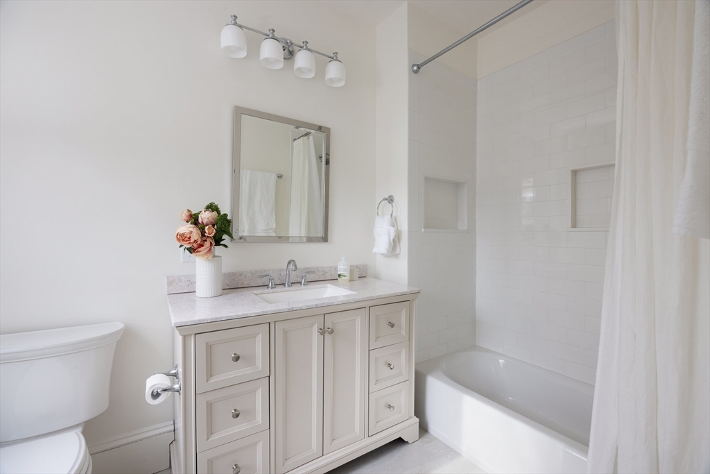 6 Warren Square, Unit 2 Boston, MA 02130 - Photo 12 of 18 a bathroom with a granite countertop sink a toilet and shower