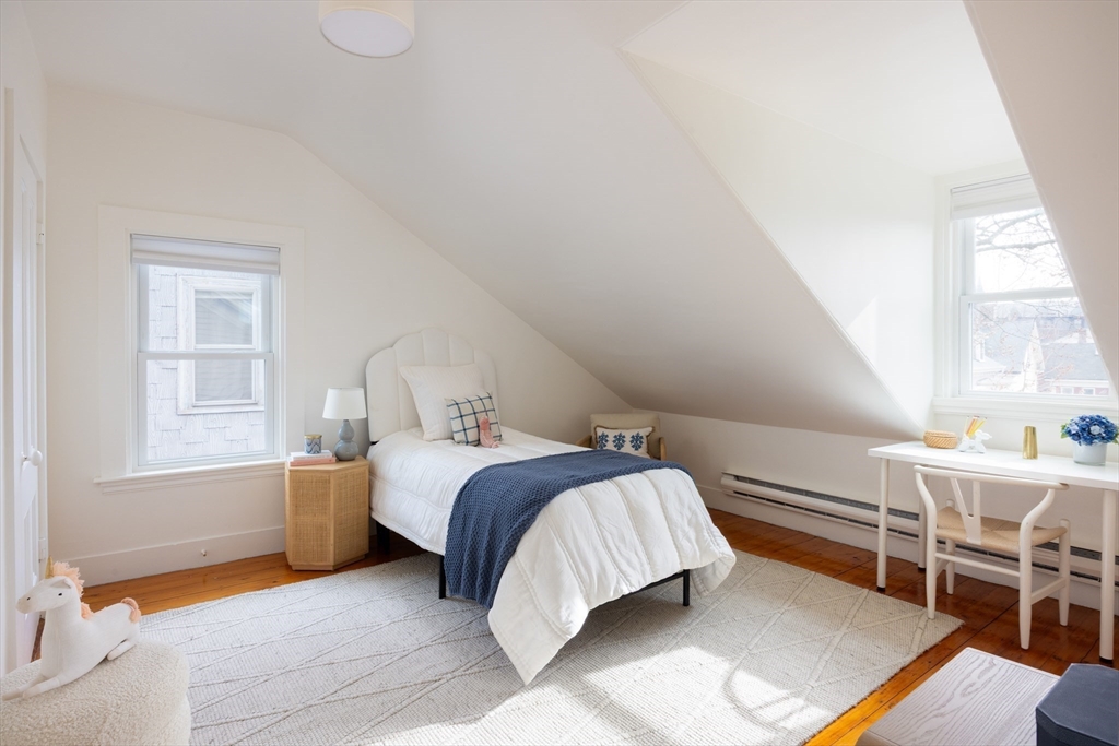 6 Warren Square, Unit 2 Boston, MA 02130 - Photo 17 of 18 a bedroom with a bed a table and windows