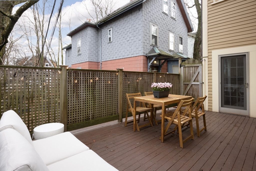 6 Warren Square, Unit 2 Boston, MA 02130 - Photo 8 of 18 a view of a patio with table and chairs with wooden floor and fence
