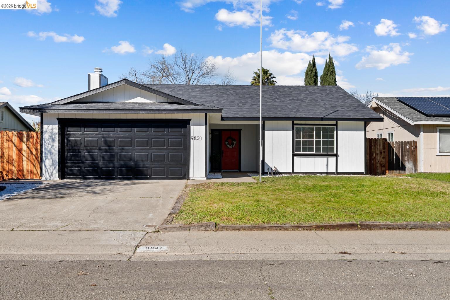 9821 Culp Way Sacramento, CA 95827 - Photo 1 of 1 a front view of a house with a yard and garage