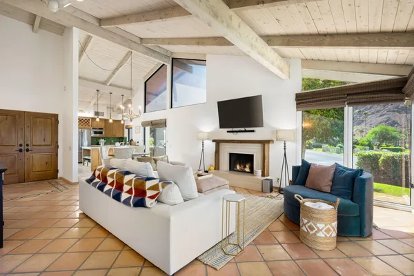 a living room with furniture a fireplace and a flat screen tv