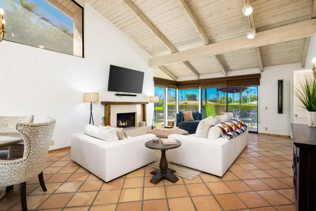 a living room with fireplace furniture and a flat screen tv