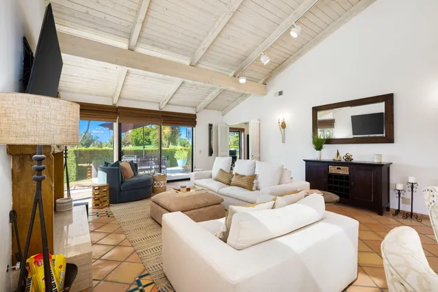 a living room with fireplace furniture and a flat screen tv