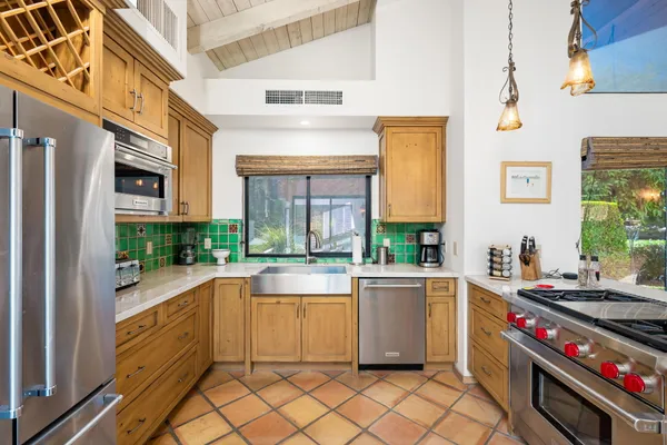 a kitchen with a stove a sink and a refrigerator