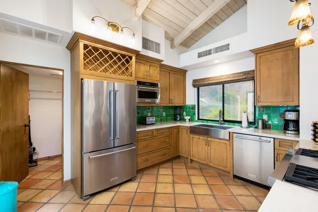 a kitchen with stainless steel appliances a refrigerator and a stove