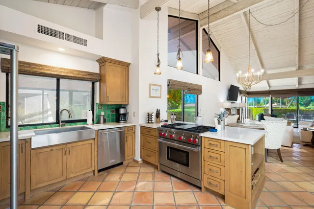 a kitchen with stainless steel appliances a stove a sink and cabinets