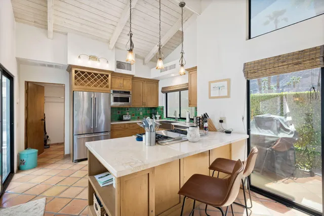 a kitchen with a table chairs and a refrigerator