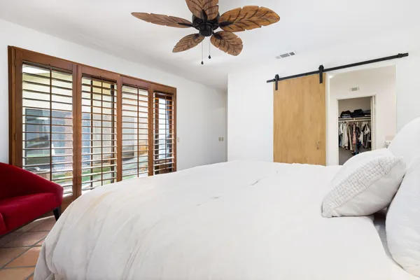 a bedroom with a bed and a chandelier