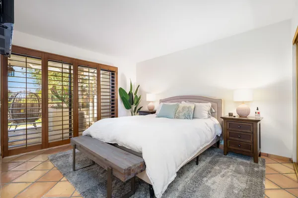 a bedroom with a large bed and a large window