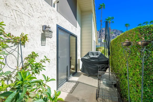 a view of a balcony with chair and potted plants
