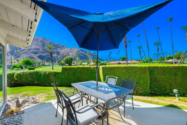 a view of a table and chairs under an umbrella