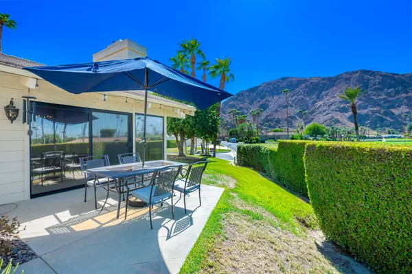 a view of a table and chairs under an umbrella