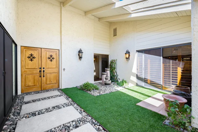 a front view of a house with garden