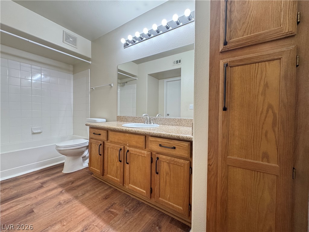 7255 West Sunset Road, Unit 2111 Las Vegas, NV 89113 - Photo 20 of 33 A well-lit bathroom showcases a vanity with ample counter space and warm-toned cabinetry.
