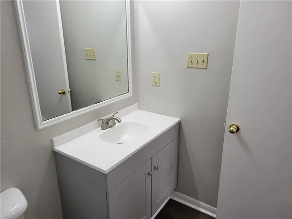 a bathroom with a sink toilet and mirror