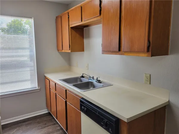 a kitchen with sink cabinets and a wooden floor