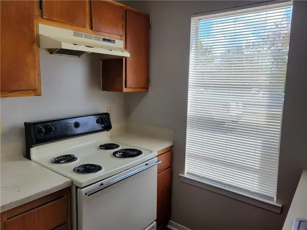 a kitchen with a stove and a microwave