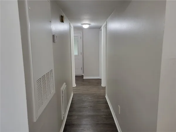 a view of a hallway with wooden floor