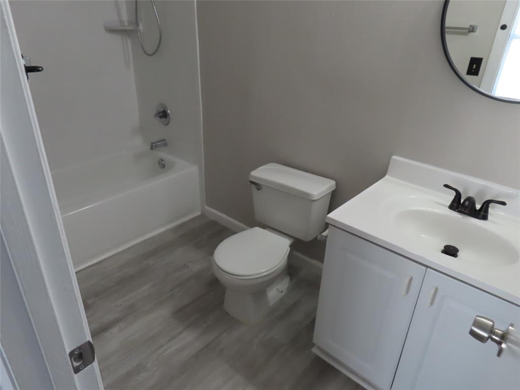 4115 Chatham Oak Court, Unit 211 Tampa, FL 33624 - Photo 11 of 21 a white toilet sitting next to a bath tub