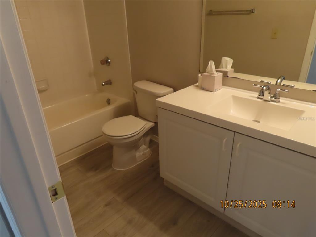 4115 Chatham Oak Court, Unit 211 Tampa, FL 33624 - Photo 18 of 21 a bathroom with a sink a toilet and shower