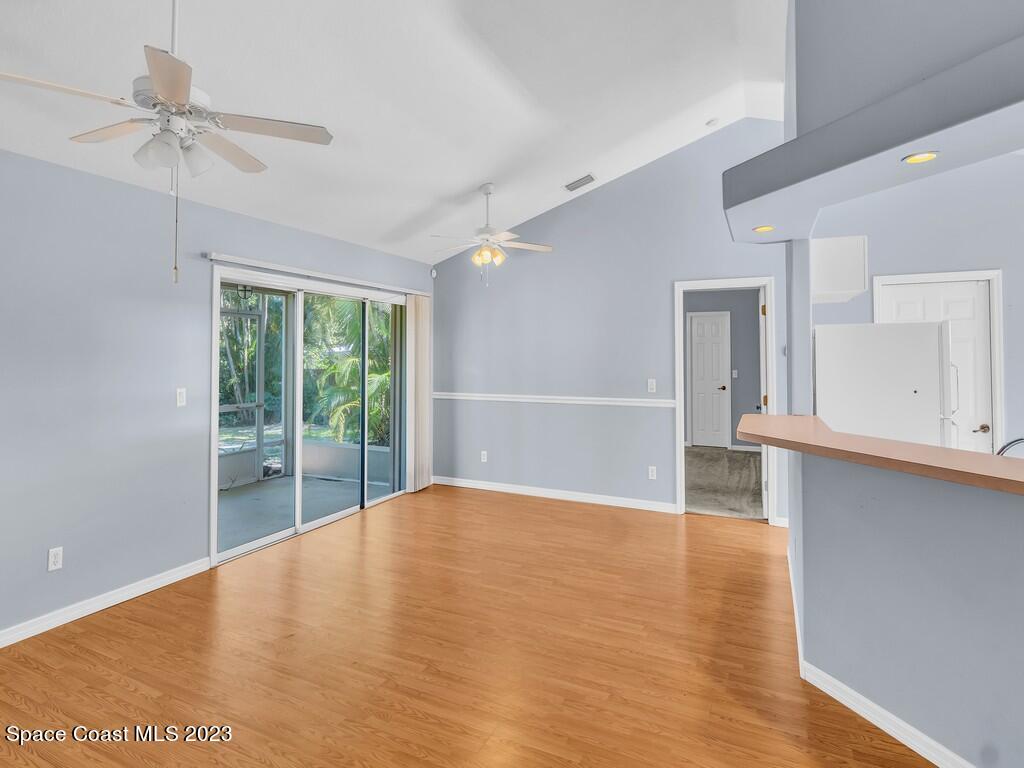 534 Sloane Street Sebastian, FL 32958 - Photo 11 of 36 a view of an empty room with a window and wooden floor