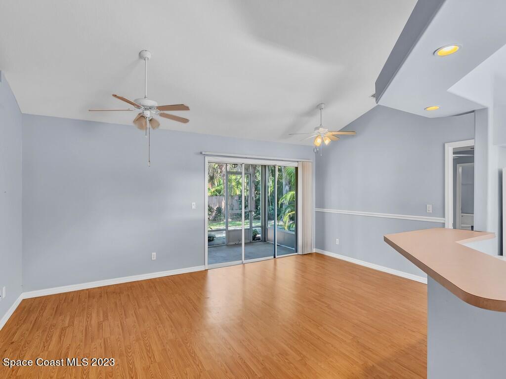 534 Sloane Street Sebastian, FL 32958 - Photo 12 of 36 a view of an empty room with a window and wooden floor