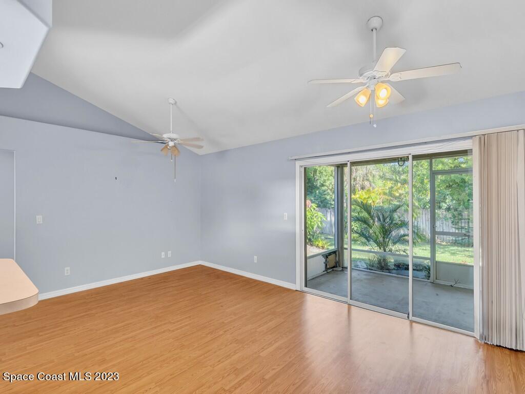 534 Sloane Street Sebastian, FL 32958 - Photo 15 of 36 an empty room with wooden floor and windows