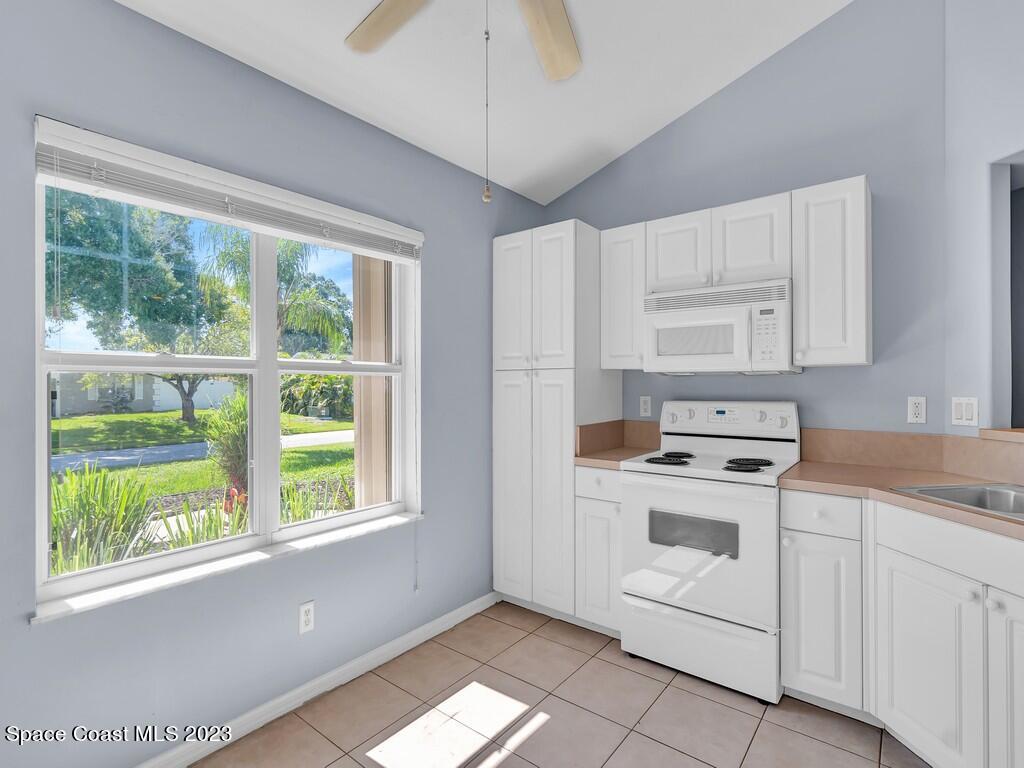 534 Sloane Street Sebastian, FL 32958 - Photo 16 of 36 a kitchen with a stove a sink and a window