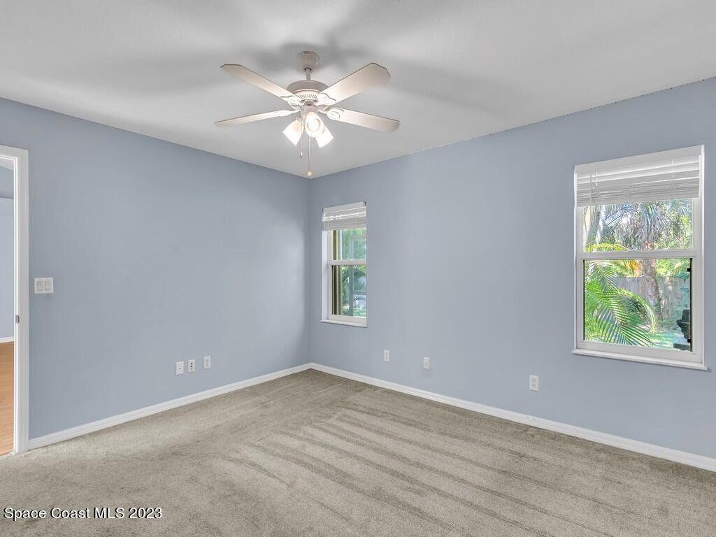 534 Sloane Street Sebastian, FL 32958 - Photo 20 of 36 a view of an empty room with wooden floor and a window