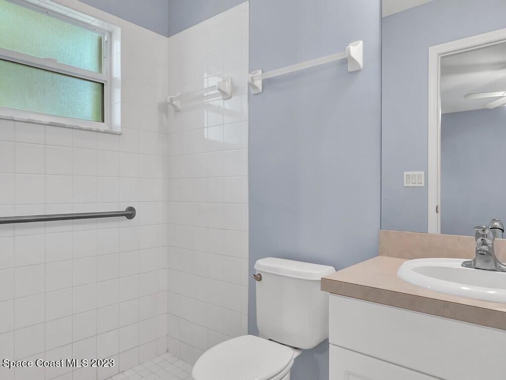 534 Sloane Street Sebastian, FL 32958 - Photo 22 of 36 a bathroom with a sink a toilet and shower