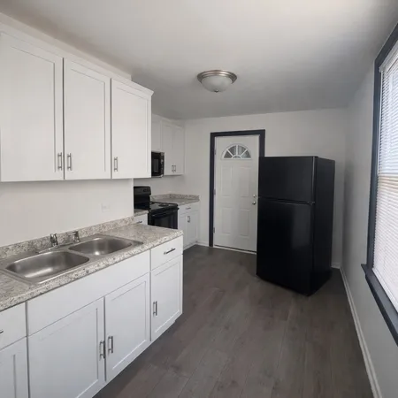 a kitchen with a refrigerator and cabinets