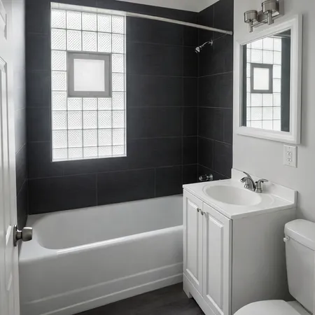 a bathroom with a sink toilet vanity and bathtub