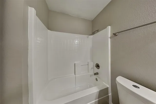 a bathroom with a bathtub and a toilet