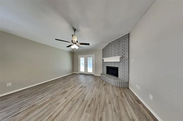 wooden floor in an empty room with a fireplace