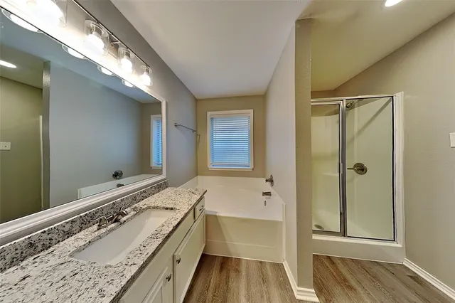 a bathroom with a tub sink and mirror
