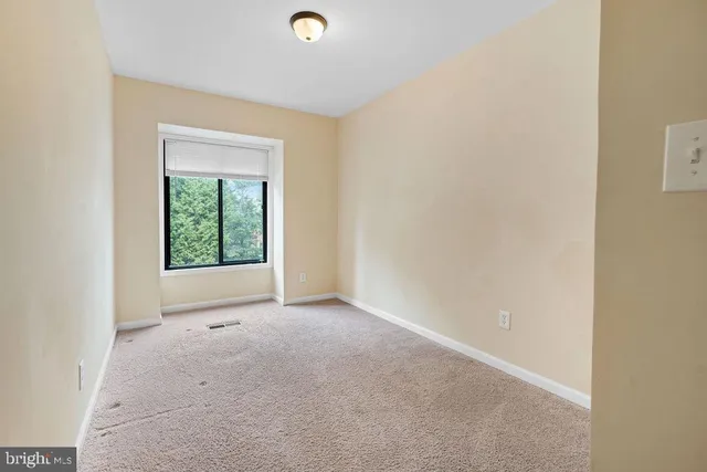 an empty room with closet area