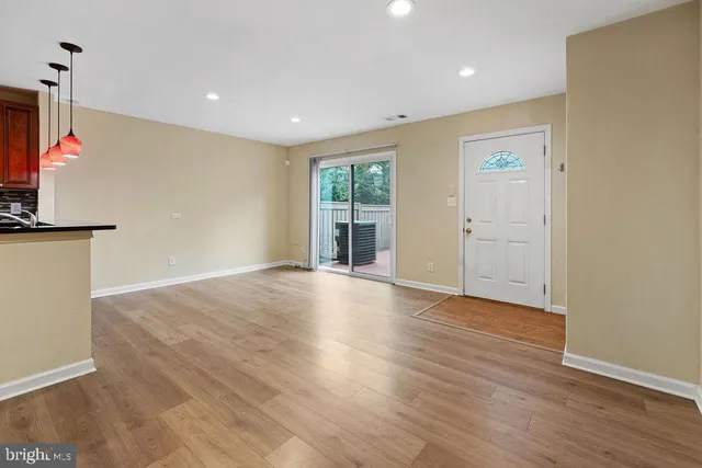a kitchen with granite countertop wooden cabinets and stainless steel appliances