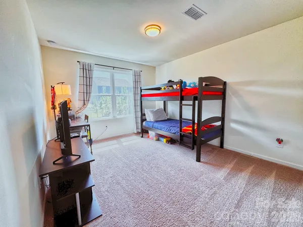 a bedroom with furniture and a baby crib