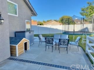 31841 Monique Circle Temecula, CA 92591 - Photo 12 of 41 a view of a patio with a table and chairs under an umbrella