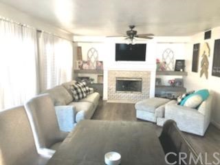 31841 Monique Circle Temecula, CA 92591 - Photo 30 of 41 a living room with furniture a flat screen tv and a fireplace