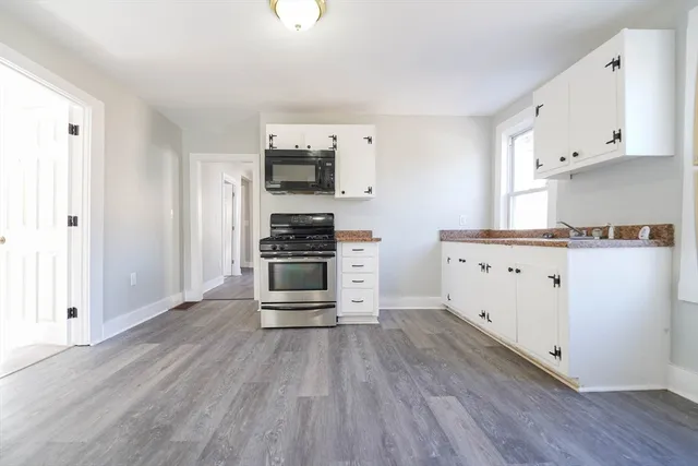 a kitchen with stainless steel appliances a stove top oven a sink and a refrigerator