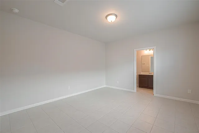 an empty room with a empty space and windows