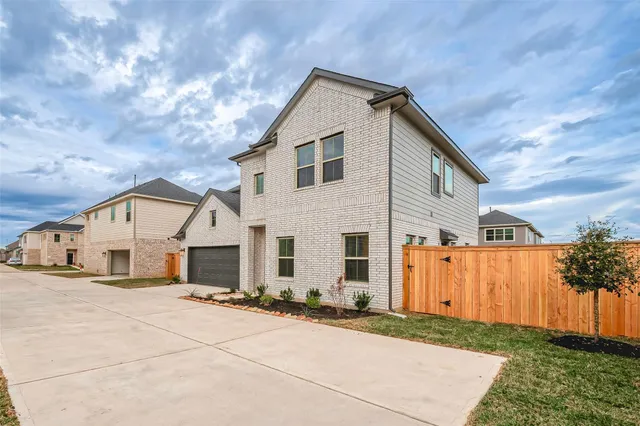 a view of a house with a backyard