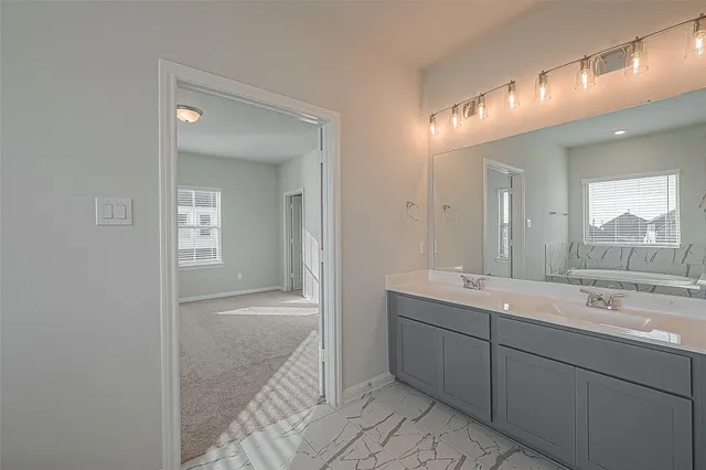 a white bath tub sitting next to a window