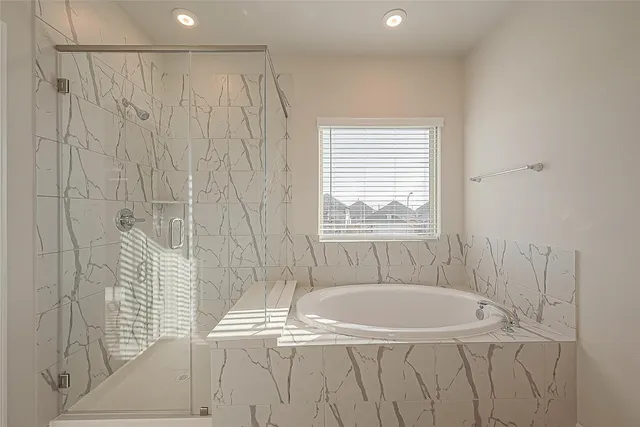 a bathroom with a bathtub and shower