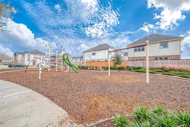 a view of a patio with lawn chairs floor to ceiling window and yard
