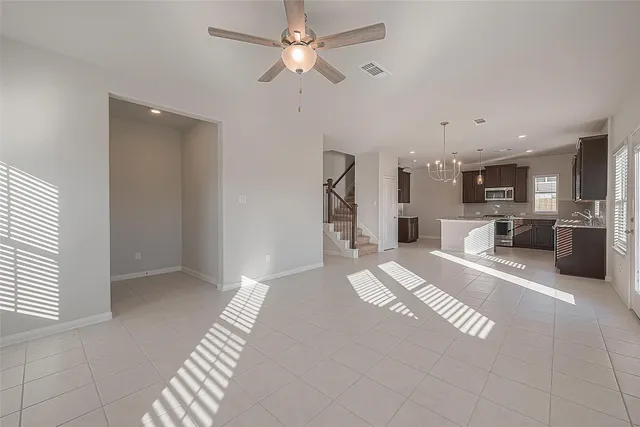 a view of a kitchen with a sink and a refrigerator