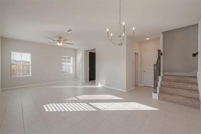 a large kitchen with stainless steel appliances kitchen island granite countertop a stove a sink a refrigerator and a microwave