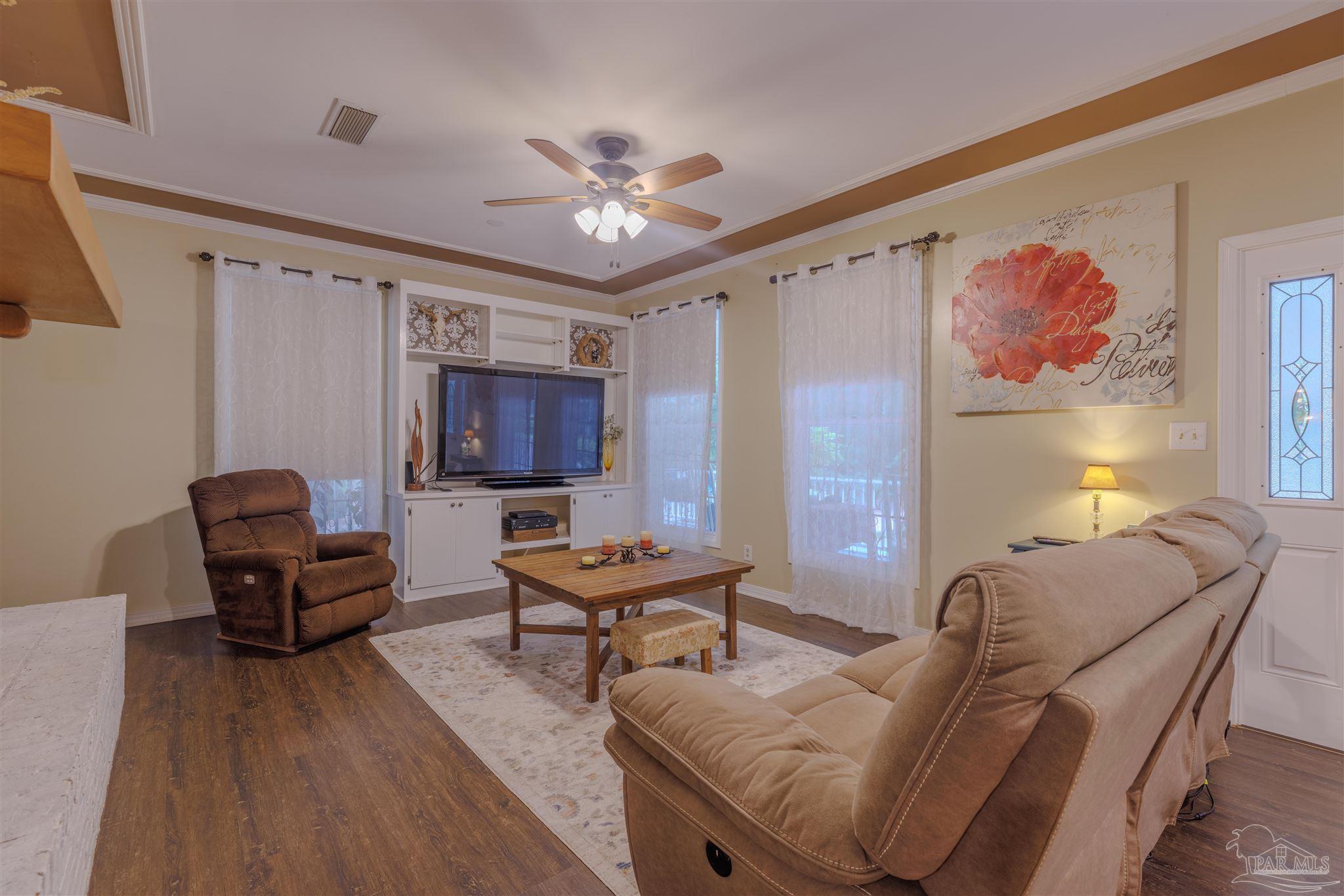 5049 Guernsey Road Pace, FL 32571 - Photo 19 of 61 a living room with furniture and a table