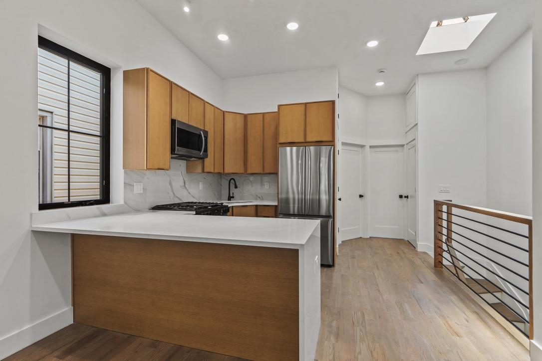 41 47th Street, Unit 2 Weehawken, NJ 07086 - Photo 14 of 22 a kitchen with a refrigerator a stove and a microwave